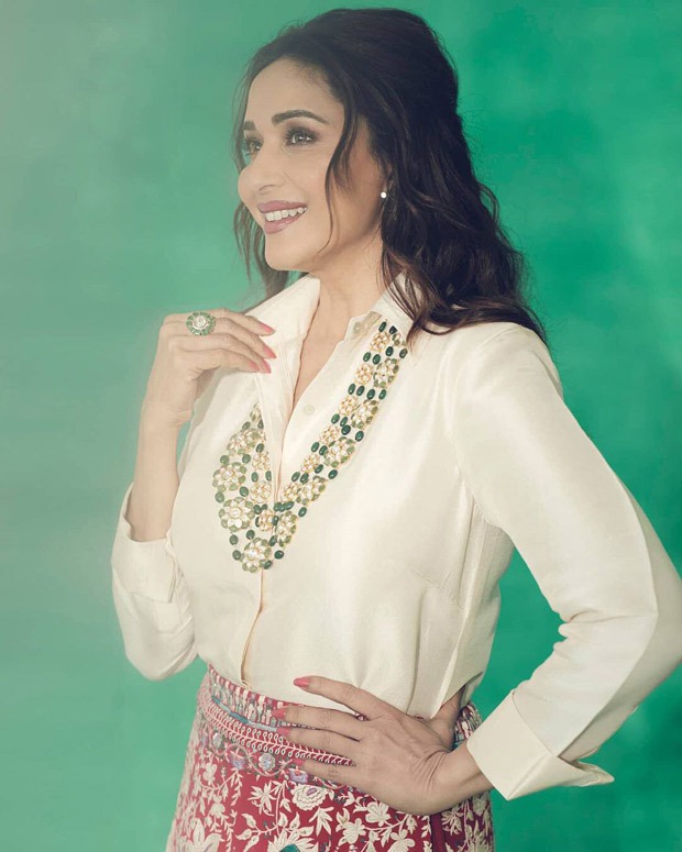 Madhuri Dixit gives modern contemporary feels by pairing a satin shirt with red lehenga skirt